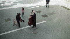 On square, in the hat that little girl throws coin